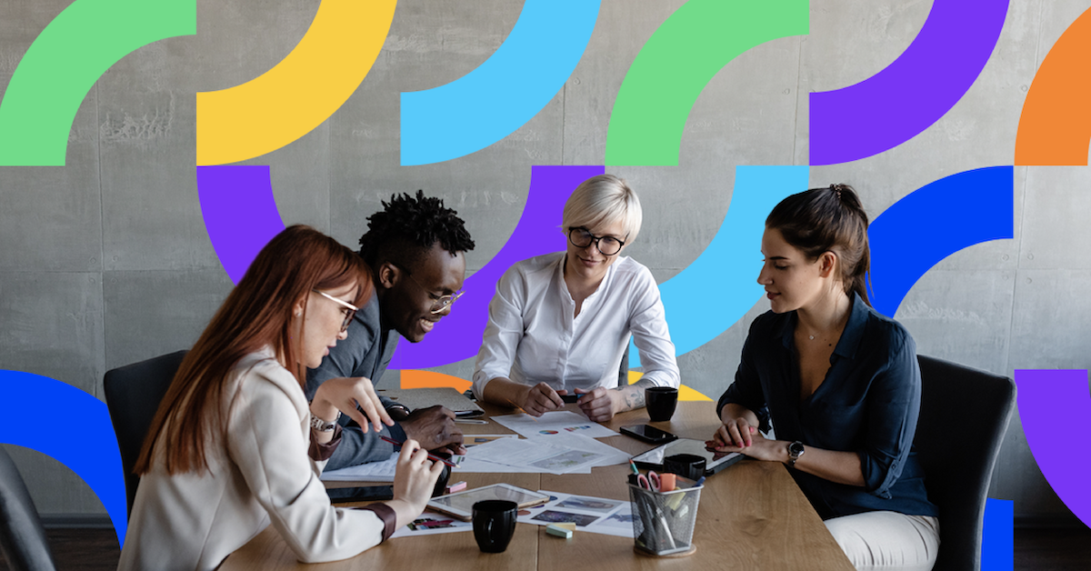 a group of people sitting at a table looking at a map