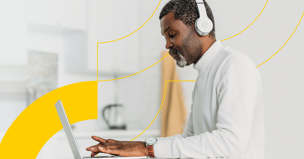 a man wearing a headset and holding a laptop