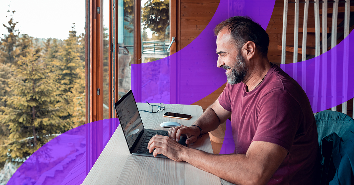 a man sitting at a table with a laptop